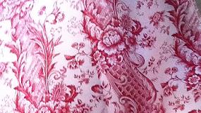 Piece of red toile de jouy fabric